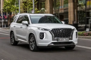 2022 Hyundai Palisade white driving on modern urban city street view